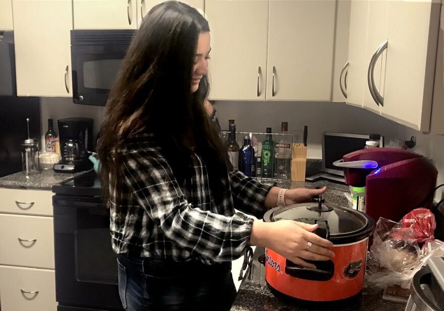 Danielle Sapp, a second-year health science major at the University of Florida sets her slow-cooker to medium heat so that her beef stew will be ready when she gets home from her last class of the day. (Jamie Shapiro / WUFT News)