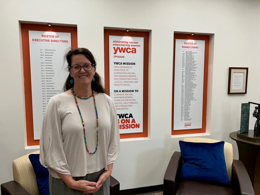 YWCA Spokane CEO Janine Wynne stands in building atrium. 