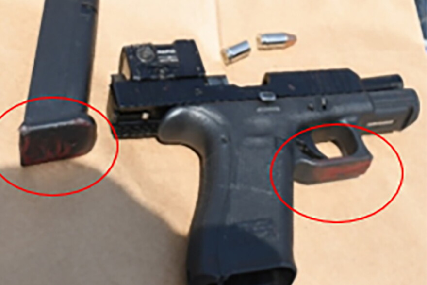A black handgun with the magazine removed.