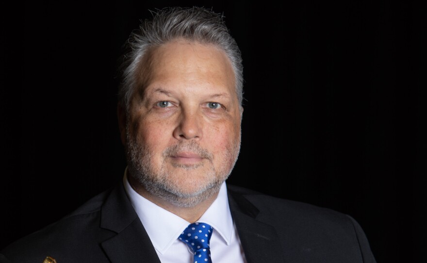 Todd Stoll holding a trumpet.