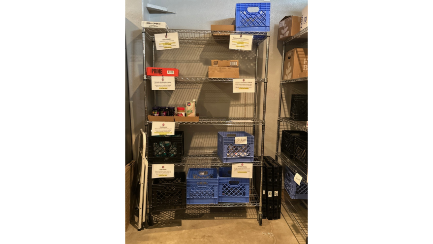 A shelf sits empty in a LIFT-UP pantry.