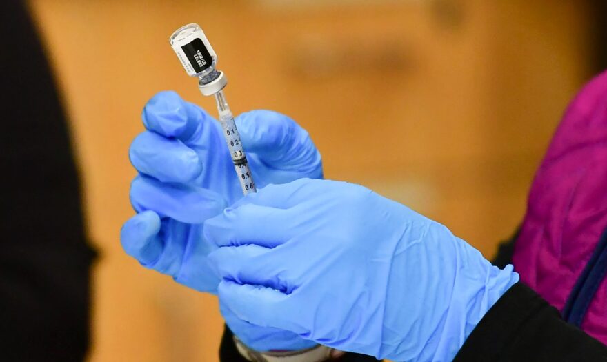 Registered Nurse Morgan James loads a syringe with a dose of the Pfizer Covid-19 vaccine at the Blood Bank of Alaska in Anchorage.