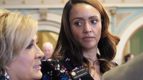 Colorado state Rep. Jamie Jackson listens to Majority Leader Monica Duran on the House floor.