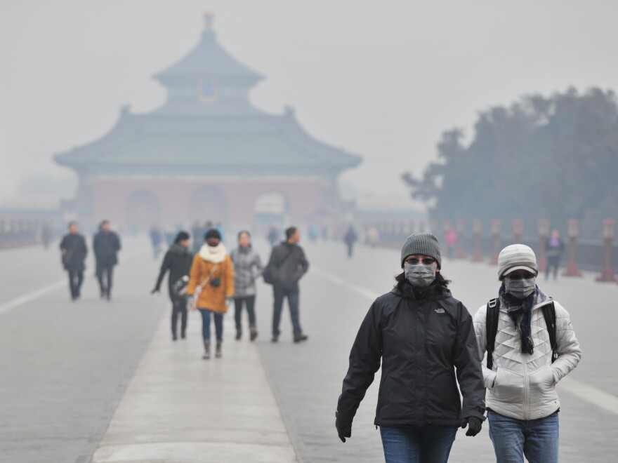 Tourists wear facial masks while visiting the Temple of Heaven Park in Beijing in January.