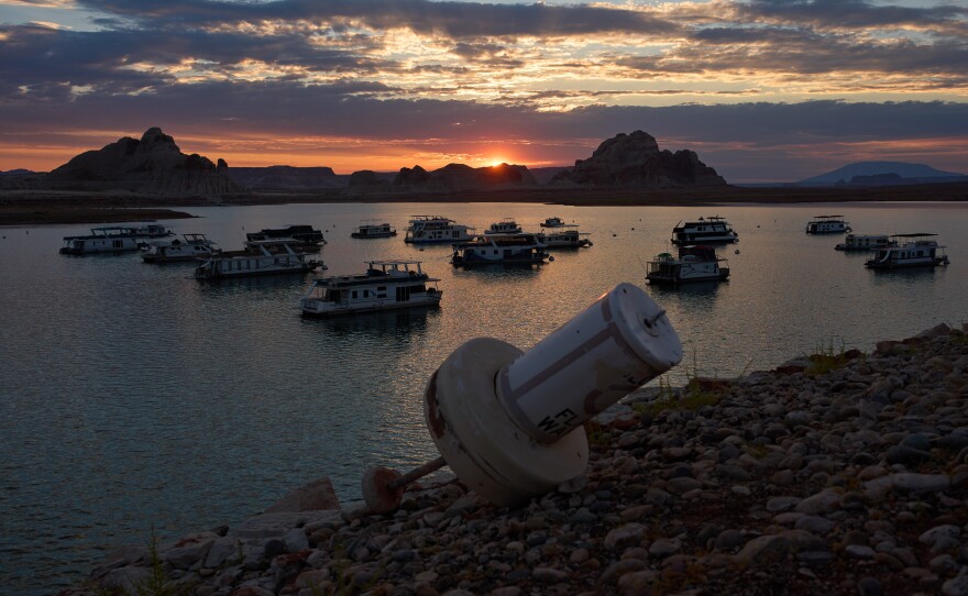 A formerly floating buoy now sits high and dry above Lake Powell at the Glen Canyon National Recreation Area, Wednesday, July 15, 2026, near Page, Nev. (AP Photo/John Locher)