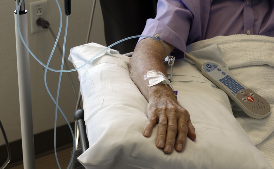 In this Thursday, Sept. 5, 2013 photo, chemotherapy is administered to a cancer patient at Duke Cancer Center in Durham, N.C. (AP Photo/Gerry Broome)