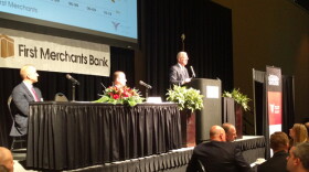 Michael Hicks (right) gives his 2020 economic forecast in Muncie.