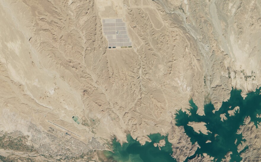 The Noor I power plant as seen from space. In the lower left, you can see the Moroccan town of Ouarzazate; in the lower right is the reservoir that is supplying the plant with water.