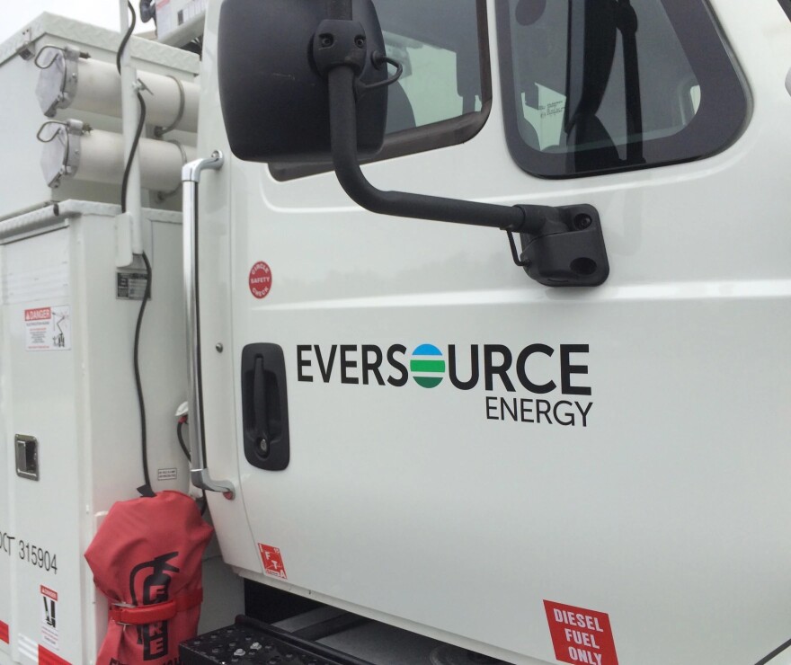 A white truck has the Eversource logo on the door.