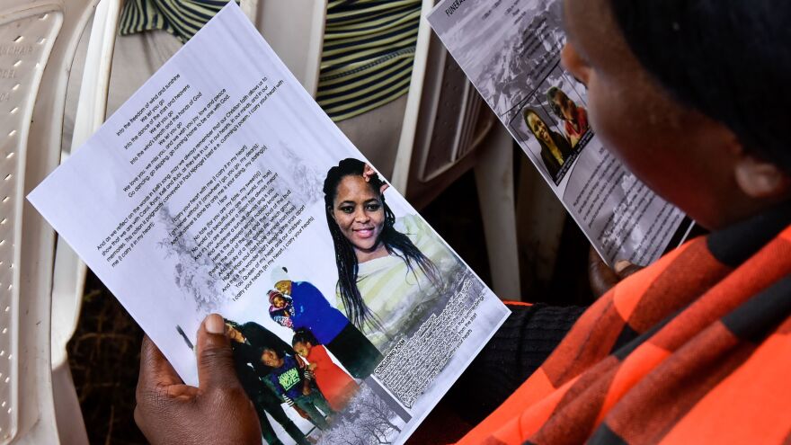 A mourner looks at pictures of four Kenyan victims of the Ethiopian Airlines crash whose remains were returned from Ethiopia this week.