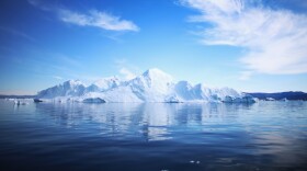 An iceberg floats through the water in Ilulissat, Greenland, in July. Researchers are studying how climate change and melting glaciers will affect the rest of the world.
