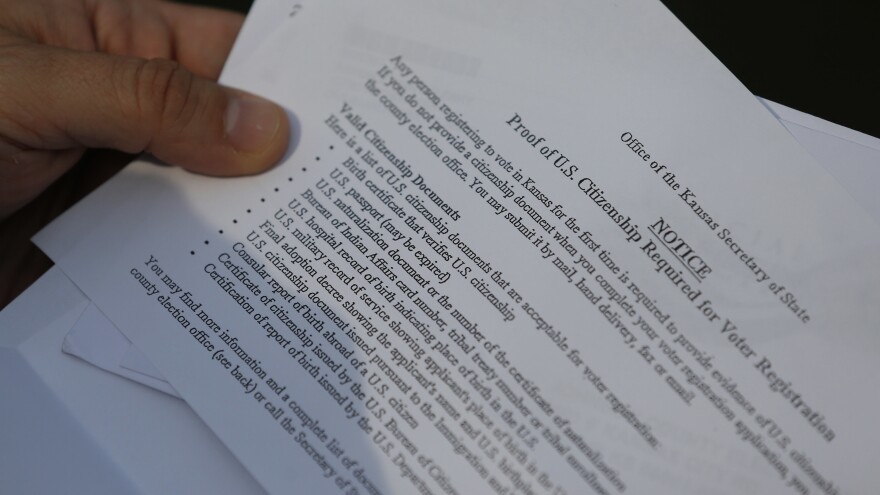 A Kansas resident shows part of a letter from election officials listing valid citizenship documents needed to register to vote in Kansas.