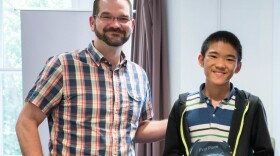 Tony Rich, the executive director of the Chess Club and Scholastic Center of Saint Louis, with junior champion Jeffrey Xiong.