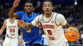 Alabama guard Labaron Philon (0) drives past Hofstra guard Cruz Davis (5) during the second half in the first round of the NCAA college basketball tournament Friday, March 20, 2026, in Tampa, Fla. (AP Photo/Chris O'Meara)