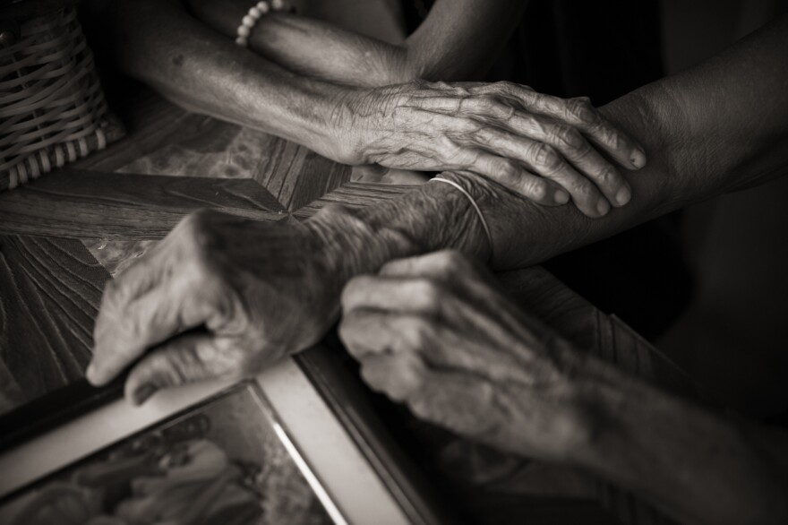 Isabelita Vinuya, Belen Alarcon Culala and Maria Lalu Quilantang clasp hands. The three women were repeatedly raped as children by Japanese imperial soldiers in their village of Mapaniqui.