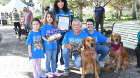 Chase Gohlke-Marino, last year's winner of the Honorary Dog Mayor contest, is surrounded by his supporters at the 22nd annual Mutt March.