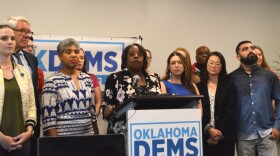 Oklahoma Democratic Party Chair Alicia Andrews (center, at lectern), is joined by State Rep. and Senator-elect Regina Goodwin (front, left) and other party members at a news conference in Tulsa on Sunday, July 21, 2024 following the announcement that President Joe Biden would end his re-election bid.