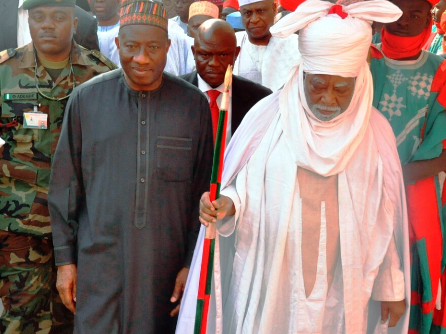 Nigerian President Goodluck Jonathan (left) walks with the Emir of Kano Ado Bayero during a one-day visit to the city that was rocked by recent attacks.