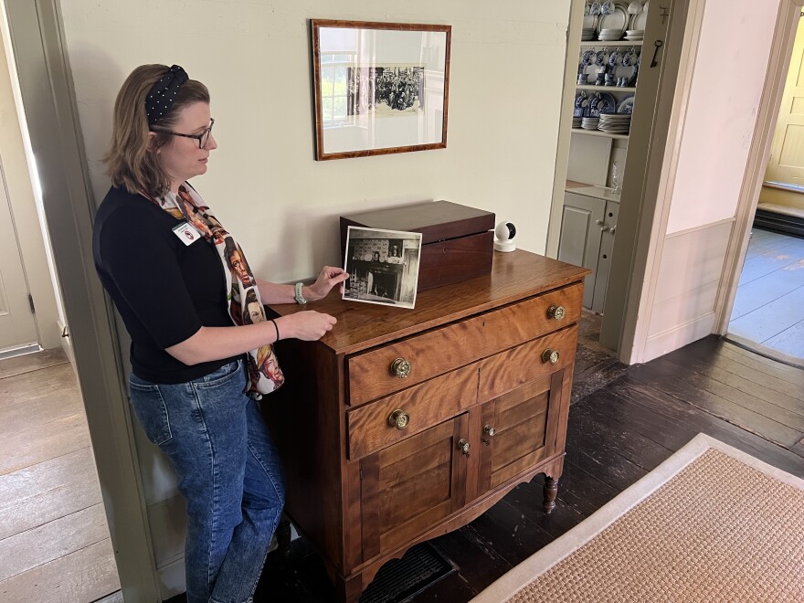 Amanda Hatch, executive director of the Frances Perkins Center, holds an old photograph showing the "winter kitchen" of the farmhouse that is now part of the Frances Perkins National Monument. The center is the philanthropic partner of the National Park Service for the monument site.