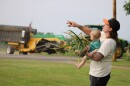 Ryan Dudek and his son, Marian, harvest garlic from the front yard of their home in King Ferry.