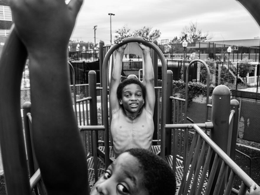 Dylan swings on a playground with his friend Sean Brown in 2016.