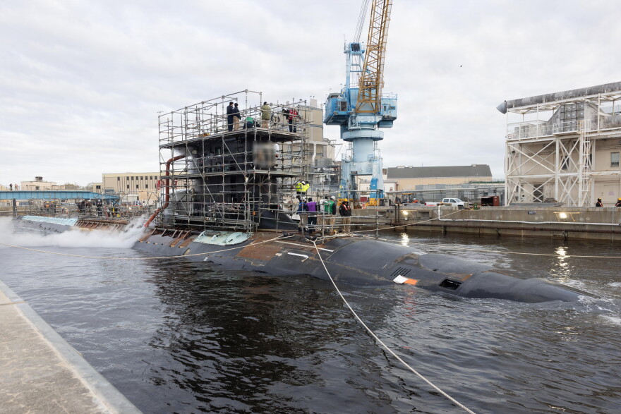 USS John Warner undergoes maintenance at Norfolk Naval Shipyard.