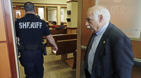 Pierce County Sheriff Paul Pastor, right, stands outside a Pierce County Superior courtroom in May 2019 following an appearance by a teen suspected in a robbery and murder of a 79-year-old convenience store owner.