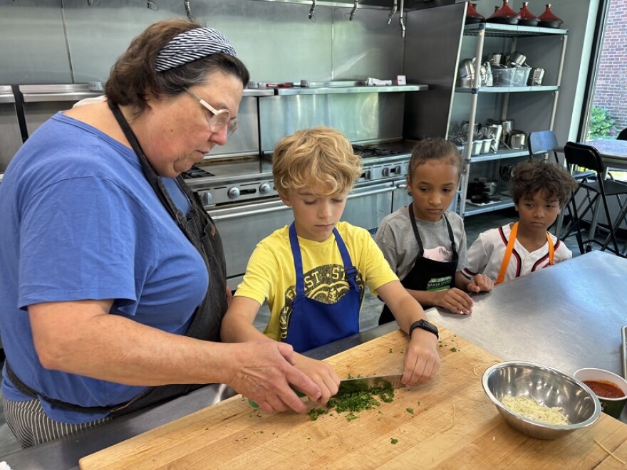 Chef Mary teaches a summer camp on a special pasta dish.