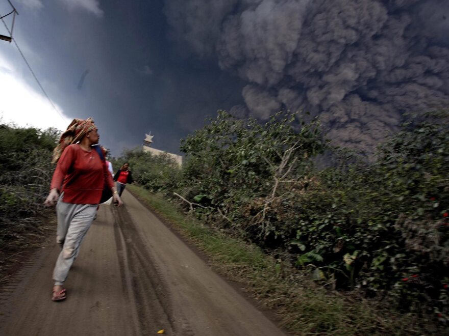 Indonesian villagers flee as Mt. Sinabung spews volcanic materials in Karo, North Sumatra, Indonesia, on Saturday.