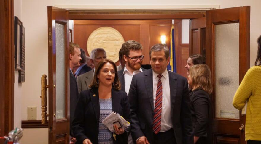 Reps. Lora Reinbold, R-Eagle River, and Chris Tuck, D-Anchorage, talk as they leave House Chambers just after midnight on July 15, 2017. The House had just adjourned the special session. (Photo by Jeremy Hsieh/KTOO)