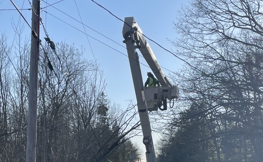 A Versant Power crew working on a line Saturday.