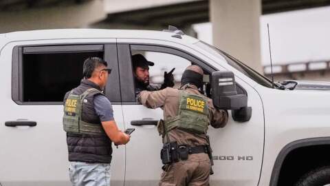 Customs and Border Patrol agents question occupants of a vehicle they pulled over, during an immigration crackdown in Kenner, La., Dec. 5, 2025. (Gerald Herbert/AP)