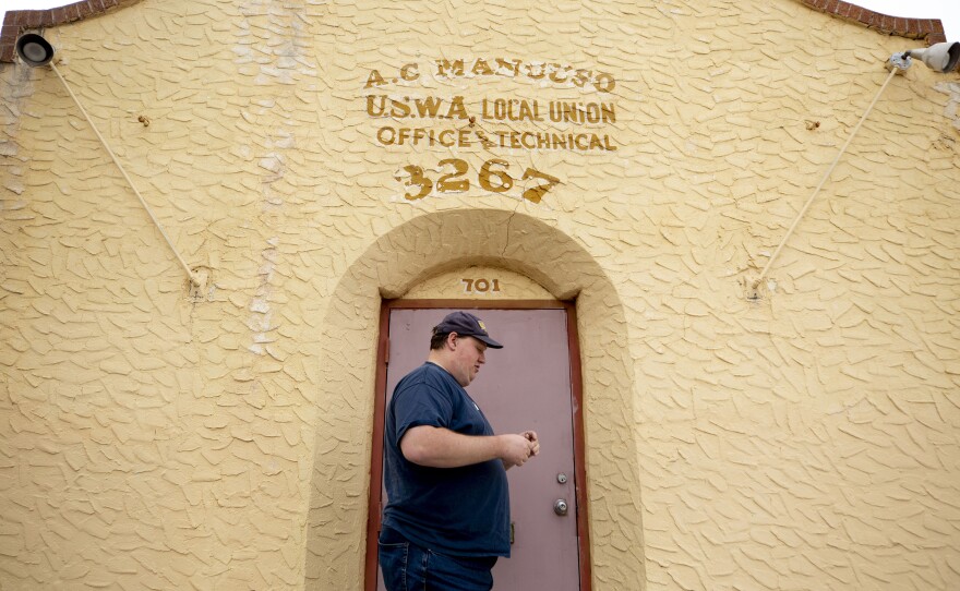 Chuck Perko, president of the United Steelworkers union Local 3267, unlocks the door to his union hall. Today the steel mill, now owned by a Russian company, doesn't have the 24-7 stream of workers that it used to.