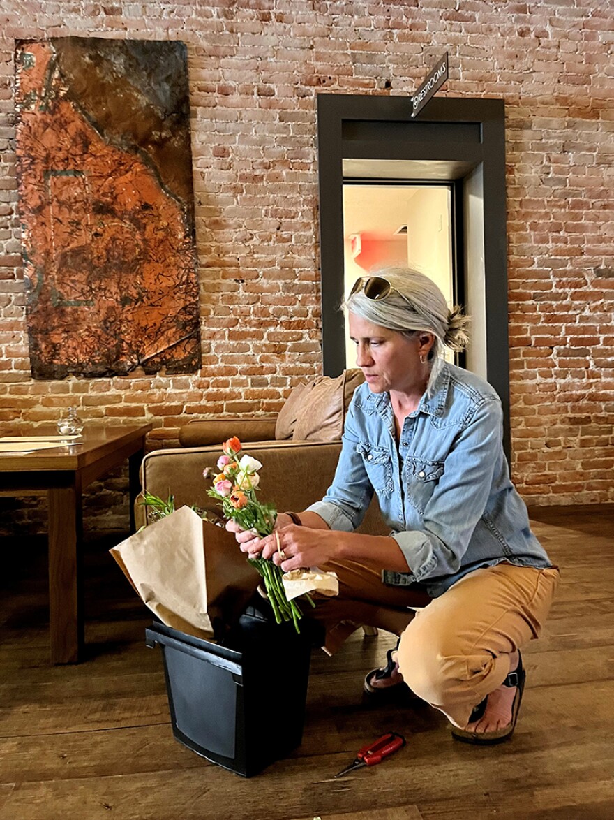 Sara Johnson of Second Bloom Flowers arranges stems at One Legged Magpie in Red Lodge