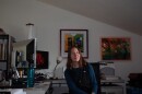 A woman sits at a computer in her office. 