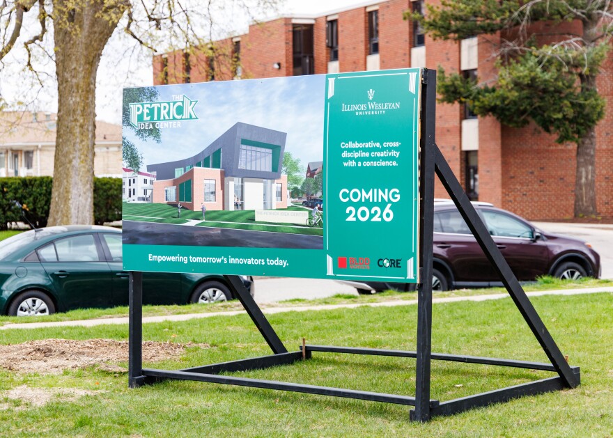 A sign advertising the new Patrick Idea Center in front of the construction site.