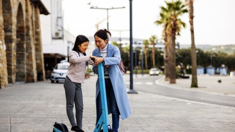 A mother shows her young daughter how to use an electric scooter. Connecticut Children's Emergency Department treated a record number of electric scooter-related trauma cases over the first weekend of August this year.