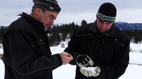 Idaho Power's Derek Blestrud and Brandal Glenn study the type of snow that's falling as a result of cloud seeding. CREDIT: AARON KUNZ