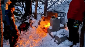 A good old-fashioned fire melts snow which then runs down the face of a rock wall at Kona Hills Campground in Marquette. The effort is meant to provide a consistent surface for climbers who come to the U.P. looking for ice, which has been less predictable in recent winters. (Photo courtesy of Kona Hills)