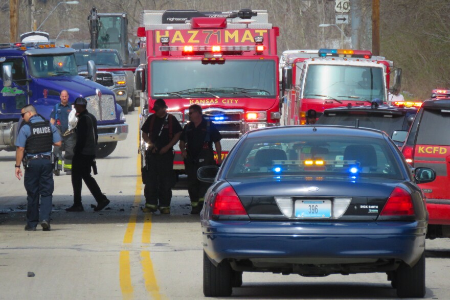 Kansas City police and firefighters work the scene of a collision Friday, March 26, 2021 on Manchester Trafficway near Highway 40.