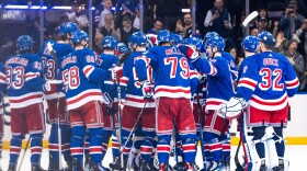 New York Rangers players gather on the ice after Adam Fox's overtime goal against the Philadelphia Flyers in an NHL hockey game Tuesday, March 26, 2024 in New York. (AP Photo/Peter K. Afriyie)