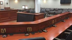 An image of Room 412 in the Capitol Building in Pierre, South Dakota, showing empty desks and chairs. 