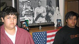 George Terrazas, 15, and Andy Terrazas, 14, flank a picture of big brother Miguel (at center of framed photo). Both young men say they plan to enlist in the Marines.