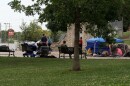 People gather at Seminary Park, some sleeping and others talking. Police and providers worry people experiencing homelessness might become harder to find after Senate Enrolled Act 285 goes into effect on Wednesday.