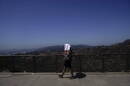 Tekosha Seals, a tourist visiting from Georgia, walks with a tower over her head at the Griffith Observatory in Los Angeles during a heat wave. (Jae C. Hong/AP)