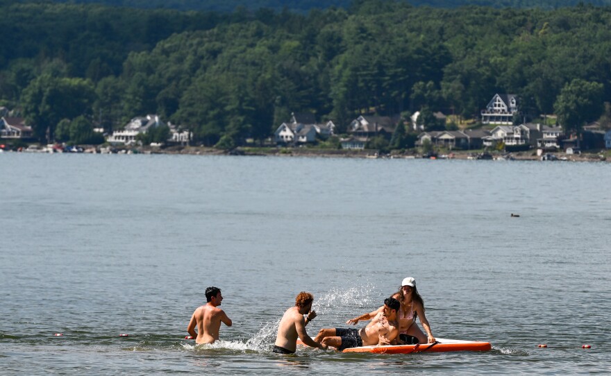A group of swimmers use a float at Palmyra Beach at Lake Wallenpaupack.