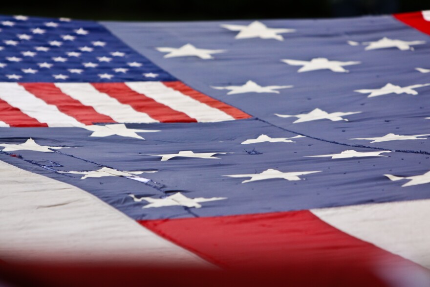 9/11 World Trade Center Flag repaired as a tribute with other retired American flags