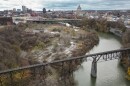 Rochester Gas & Electric, Bausch + Lomb and other businesses used to fill the Genesee River gorge south of the railroad bridge. The Smith Street or Bausch Memorial Bridge is seen in the distance. This is area will make up the northern and eastern parts of the planned High Falls State Park. This aerial photo is looking south toward downtown.