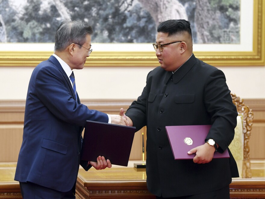 South Korean President Moon Jae-in (left) and North Korean leader Kim Jong Un shake hands after signing a joint declaration at the Paekhwawon State Guesthouse in Pyongyang, North Korea, on Wednesday.