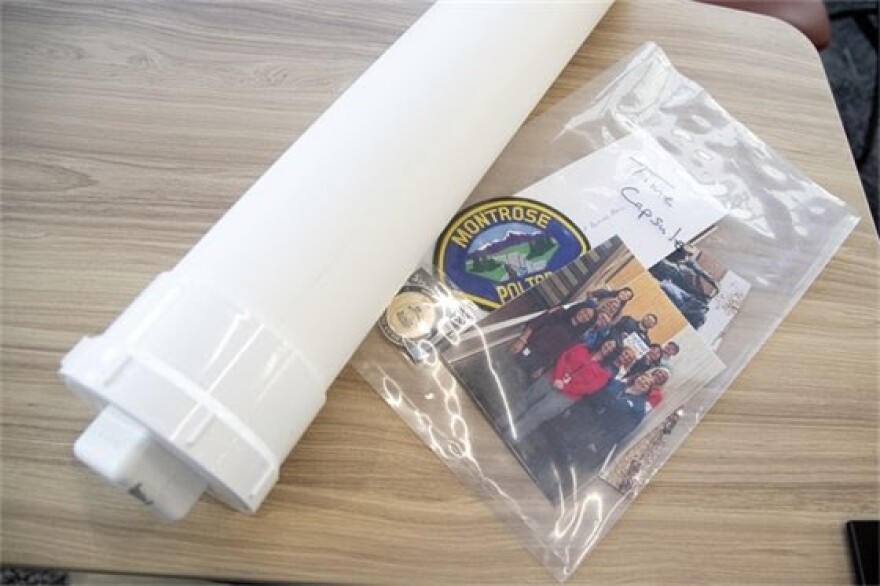 A collection of various Montrose Police Department public safety memorabilia sit ready to be inserted into a time capsule constructed from heavy tubing inside the Montrose Police Department on Monday, April 3.